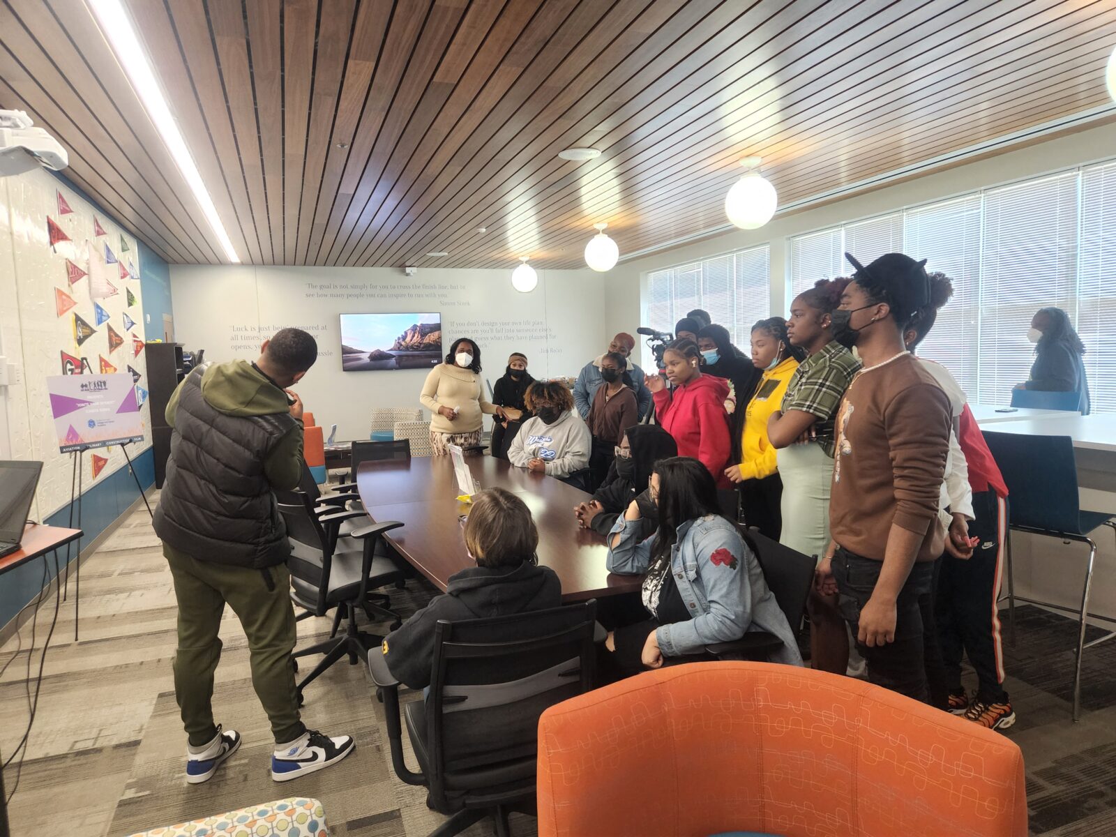 Man teaching a group of high school students in classroom